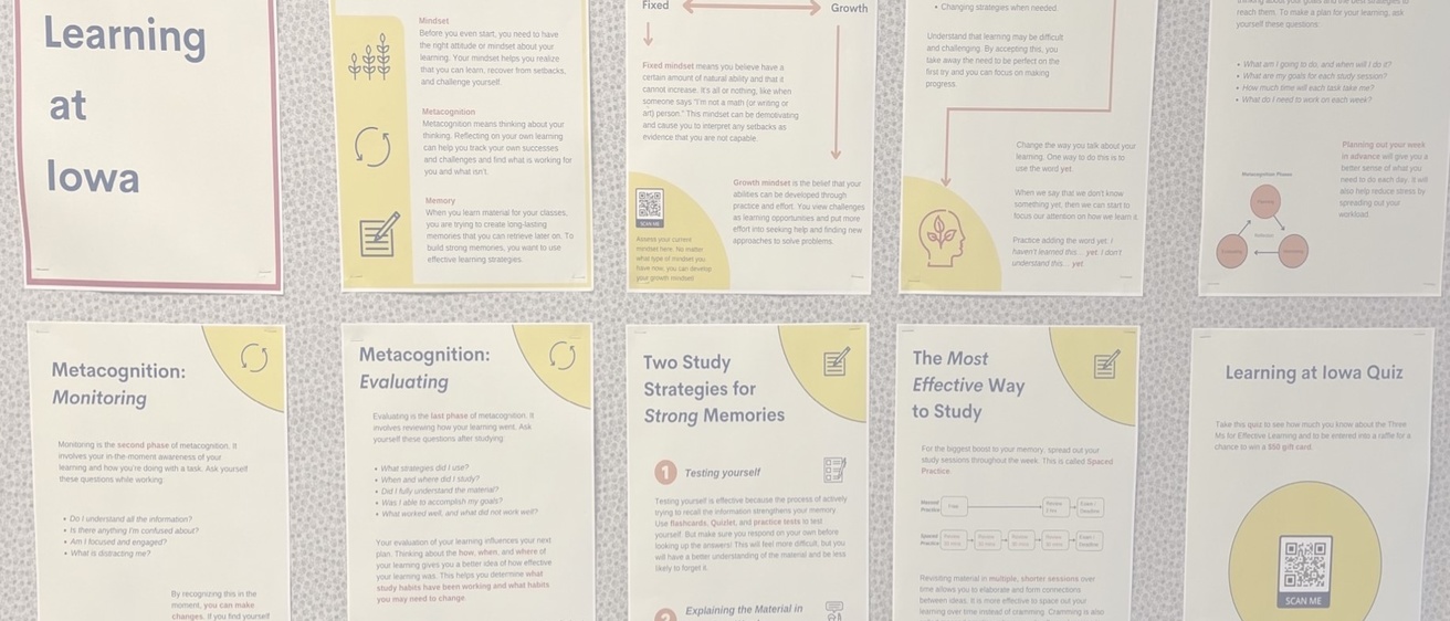 Ten printed posters hung on a residence hall bulletin board with Learning at Iowa content