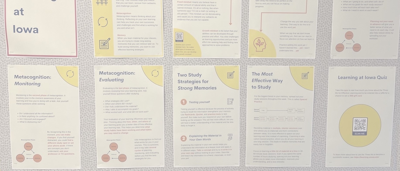 Ten printed posters hung on a residence hall bulletin board with Learning at Iowa content